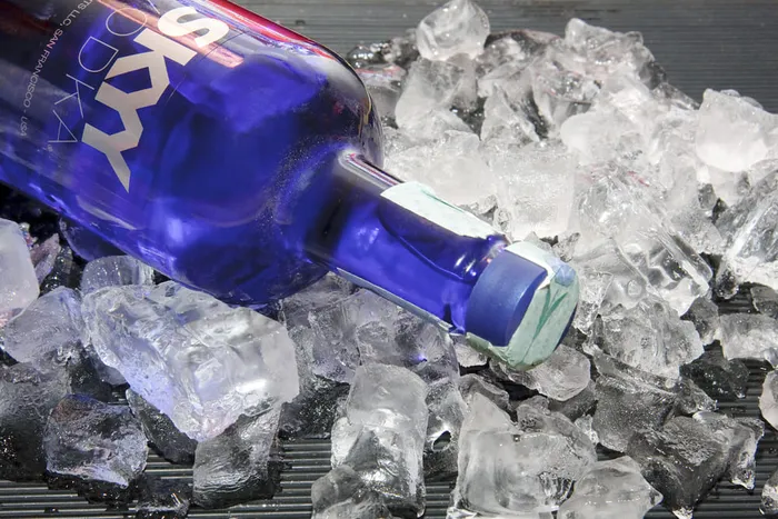 Skyy Vodka bottle laying on ice